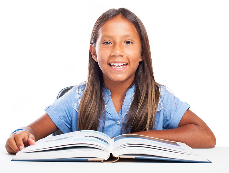 smiling girl in front of an open textbook