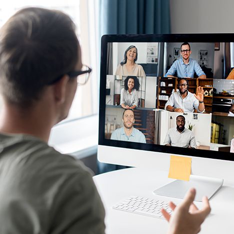 man having a zoom meeting with his colleagues